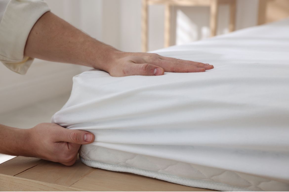 Fitting a deep fitted sheet over a thick mattress