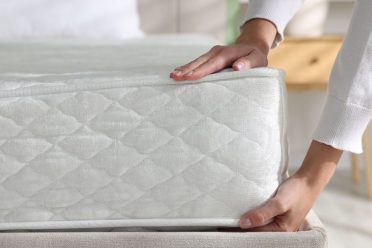 Person checking mattress thickness